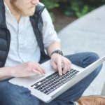 A professional working on a laptop outdoors