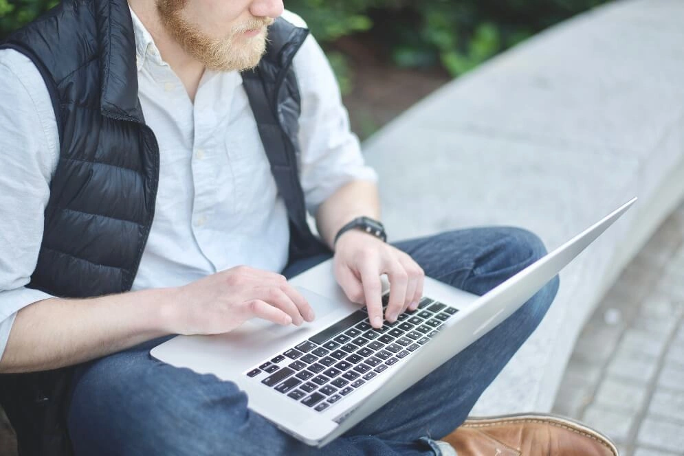 A professional working on a laptop outdoors